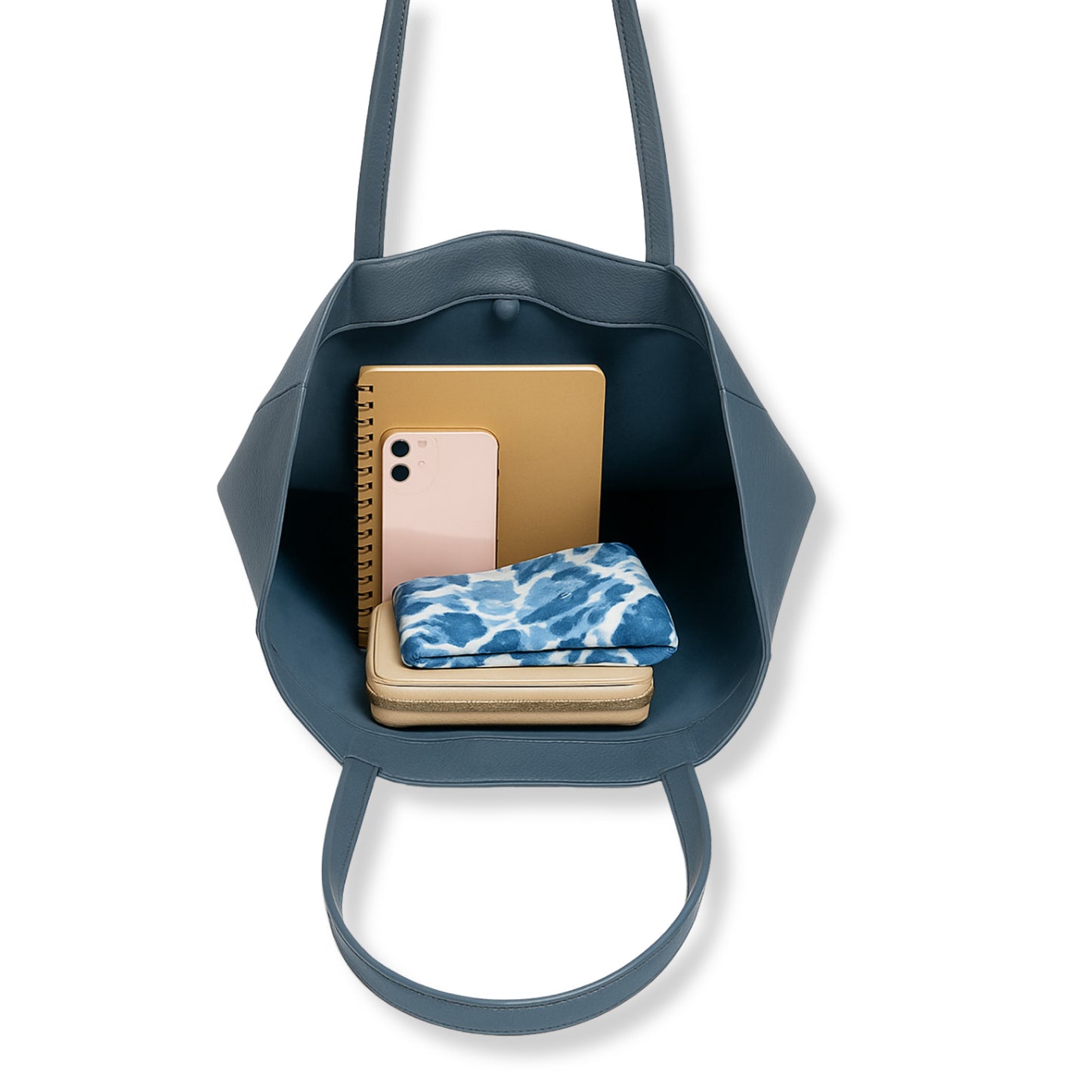 Denim Blue real leather tote bag interior showing notebook, phone, and glasses neatly arranged.