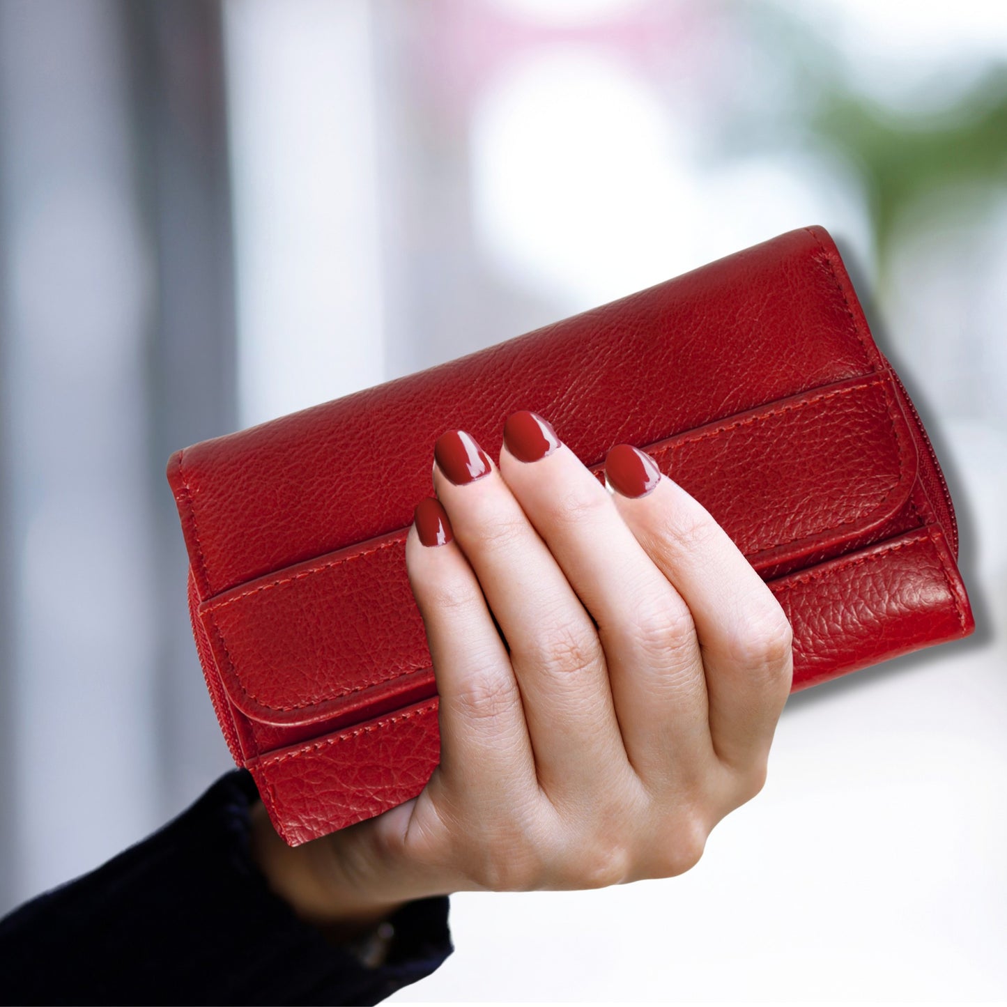 Close-up of a red RFID leather wallet held in hand, showcasing its vibrant colour and textured finish