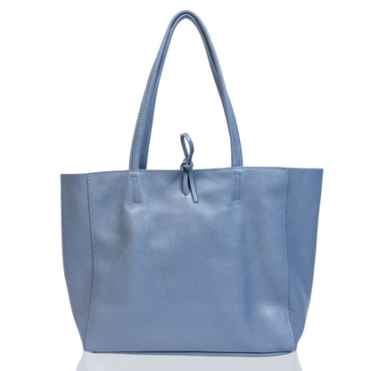 Front view showing denim blue full grain leather tote bag with zip top and twin shoulder straps.