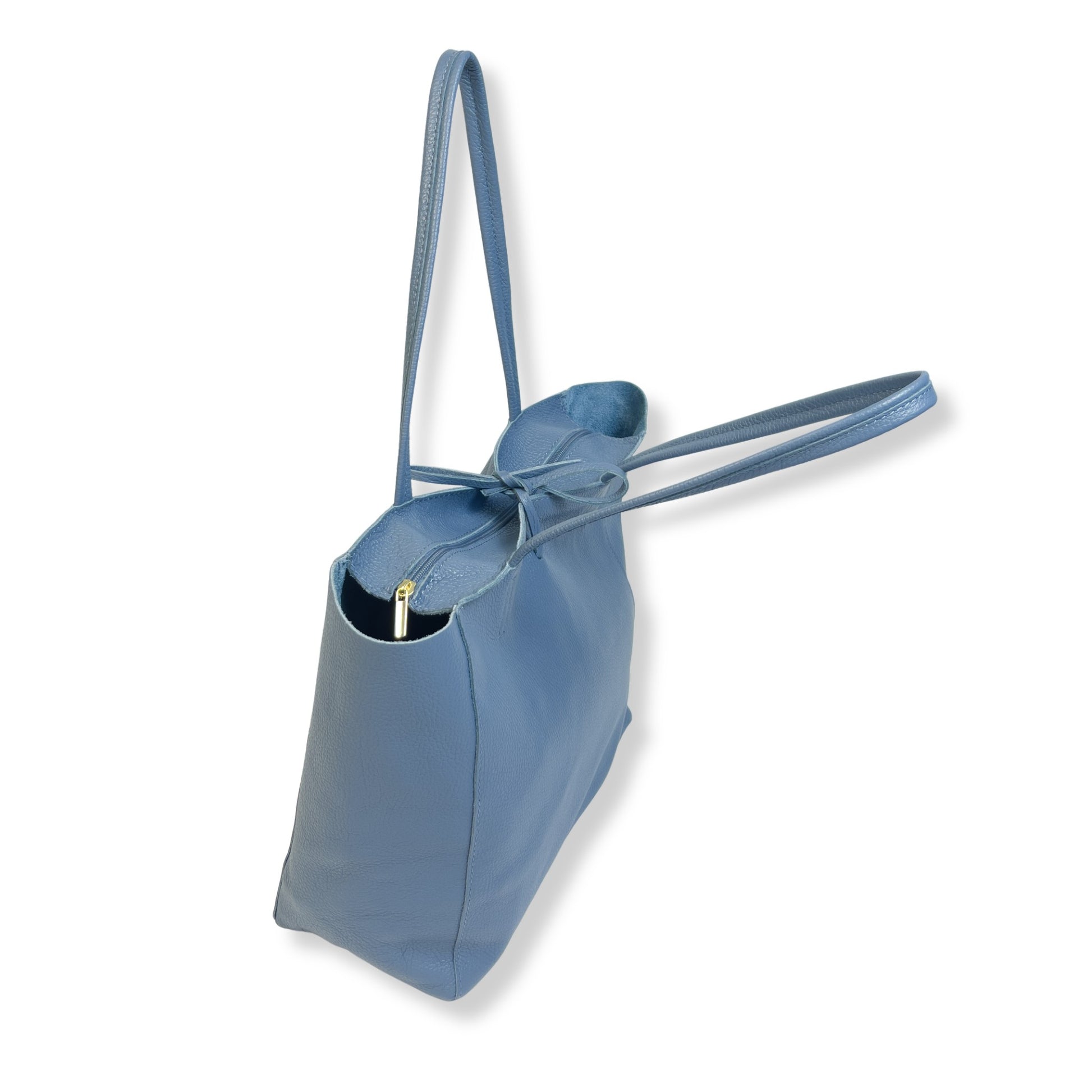 Tied top view of denim blue real leather tote bag with twin handles and soft tie fastening.