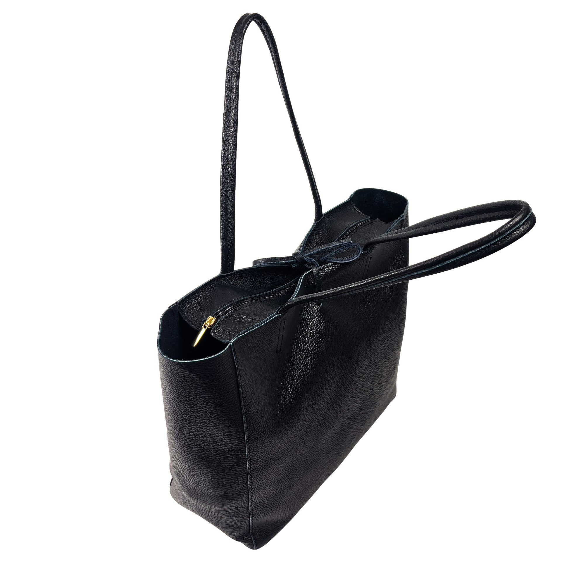 Top tie detail of black full-grain leather tote bag showing secure closure design