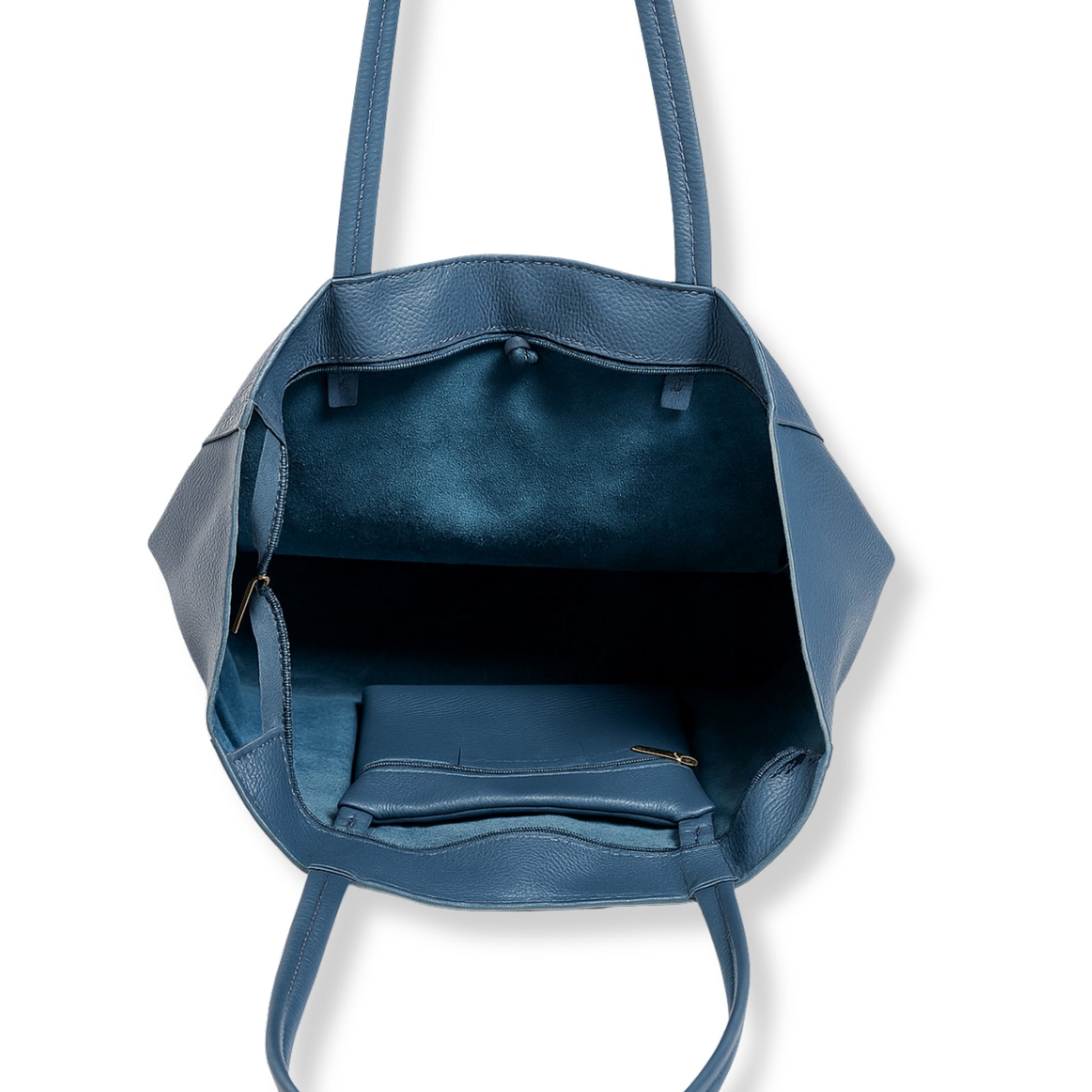 Interior view of denim blue real leather tote bag showing internal zip pocket and unlined craftsmanship.