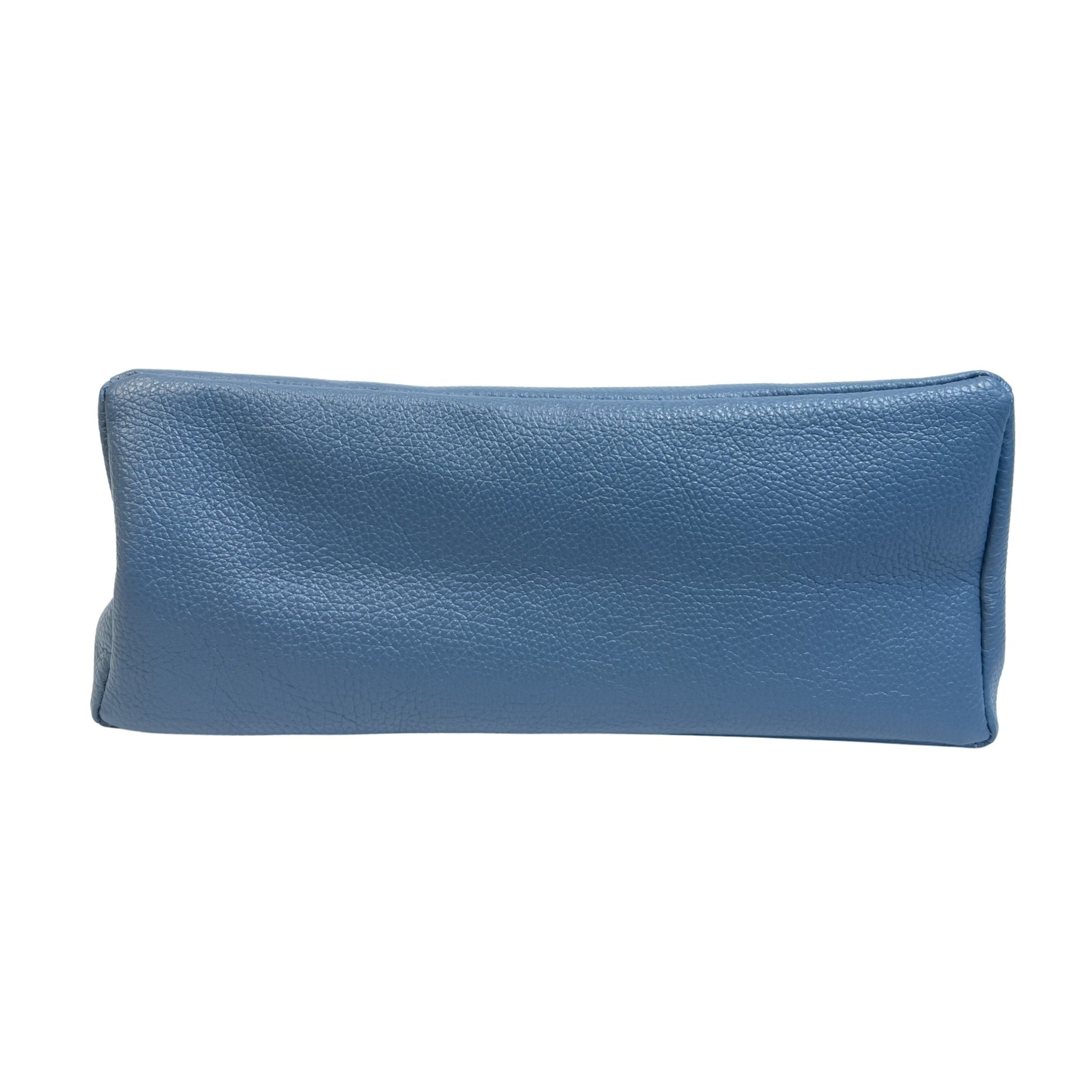 Base view of denim blue real leather tote bag showing detailed stitching and reinforced base seams.