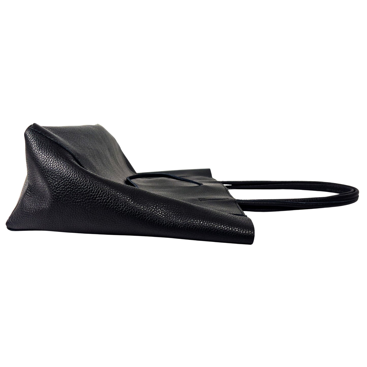 Side profile of black full-grain leather tote bag showing structured seams and depth