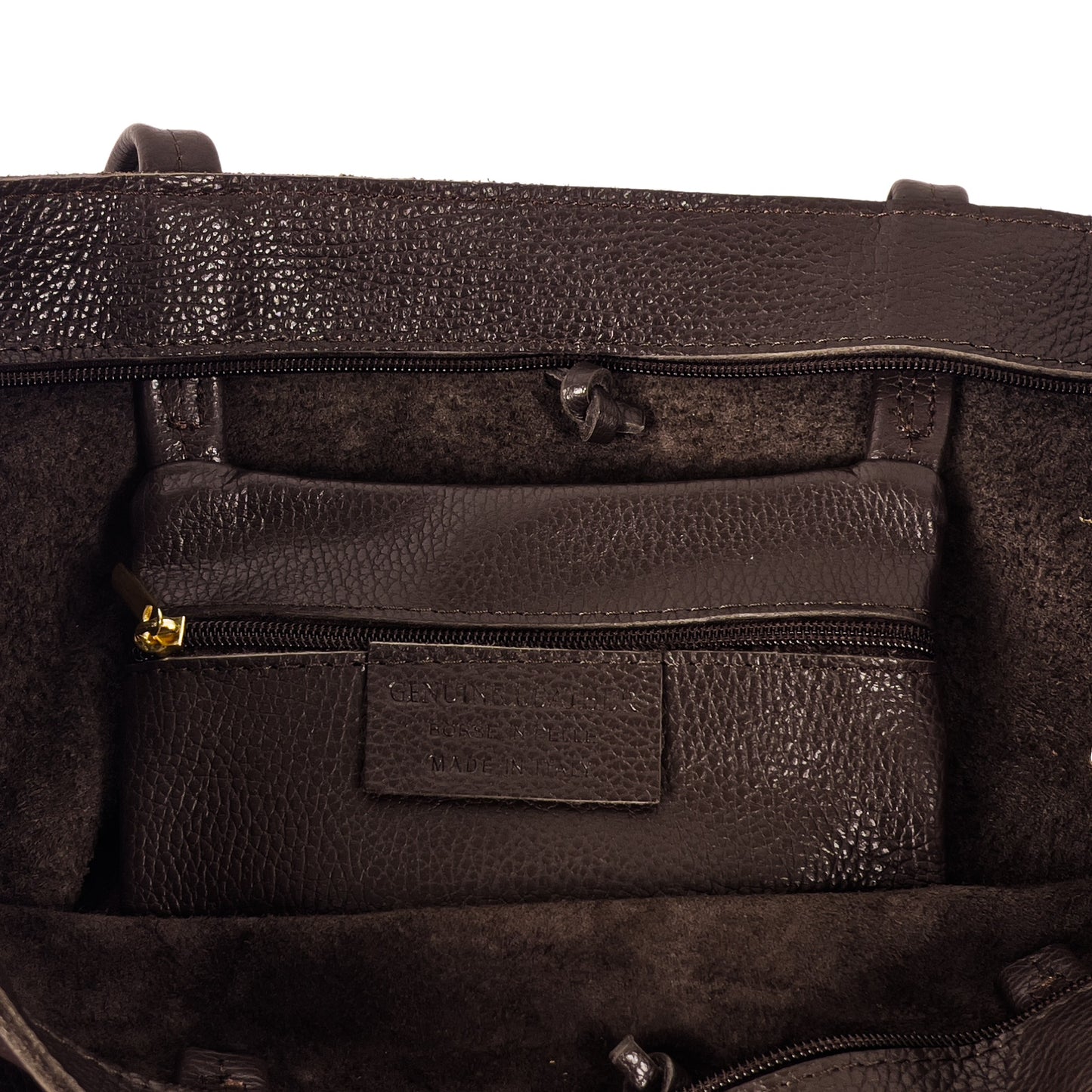 Internal detail of dark chocolate real leather tote bag showing stitching and zip