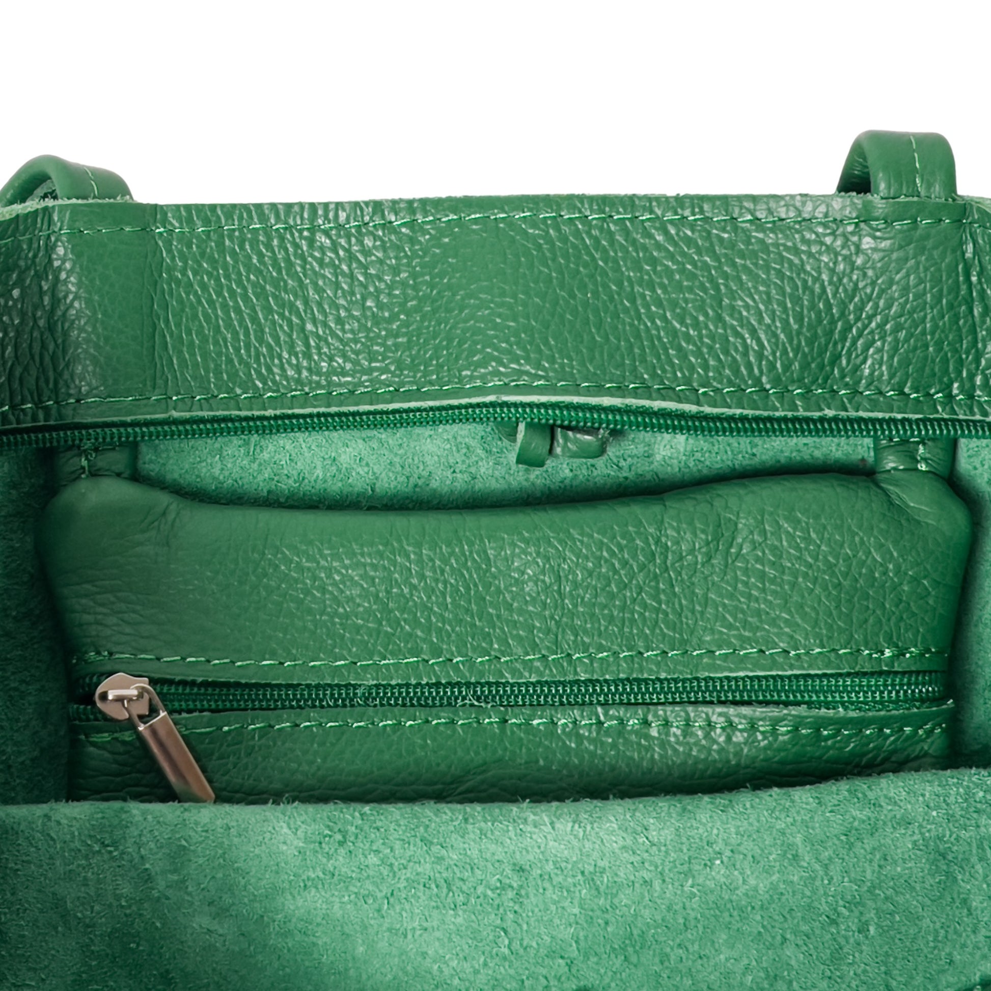Internal close-up of green Italian leather tote bag showing stitching and lining
