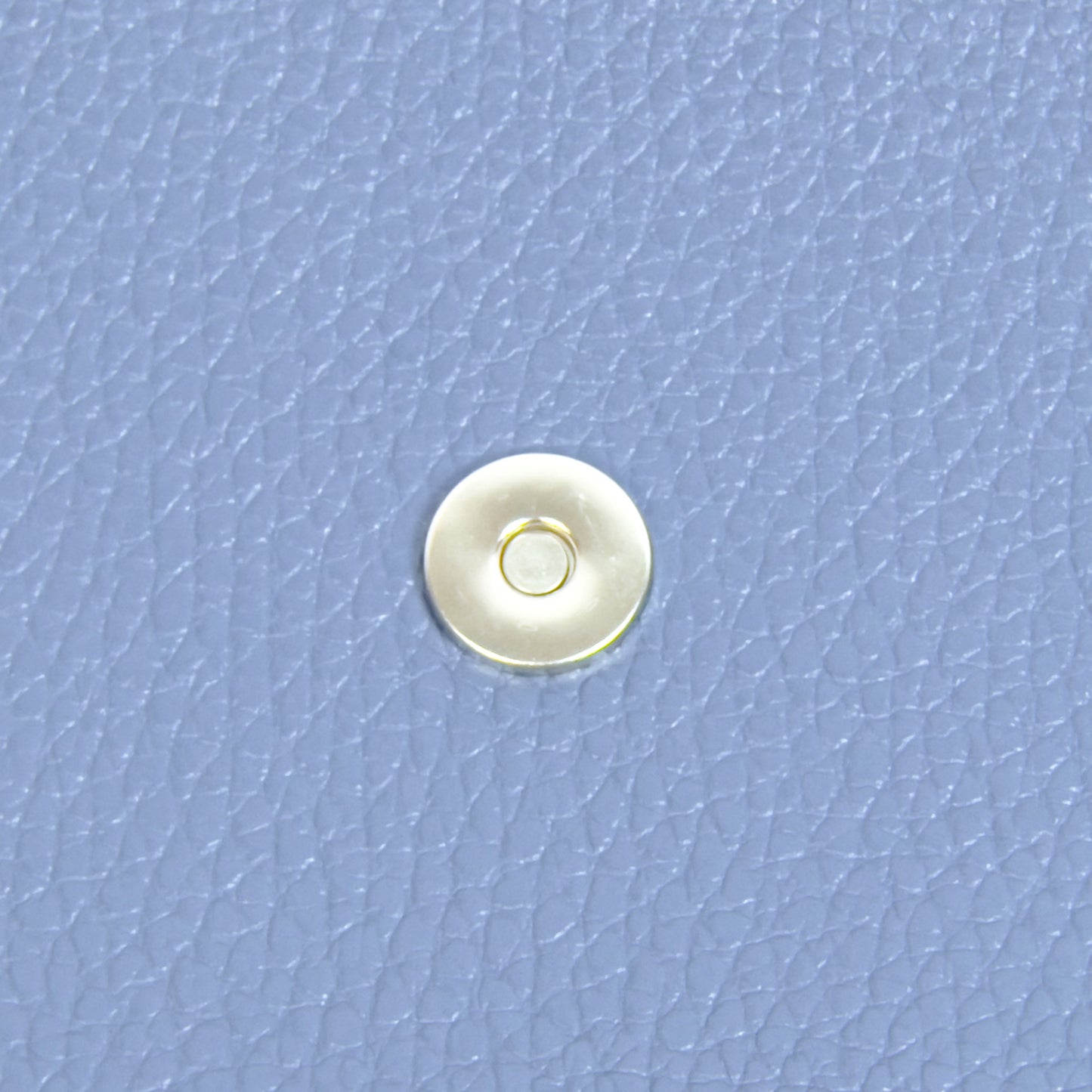 Denim blue leather phone purse magnetic clasp detail close up
