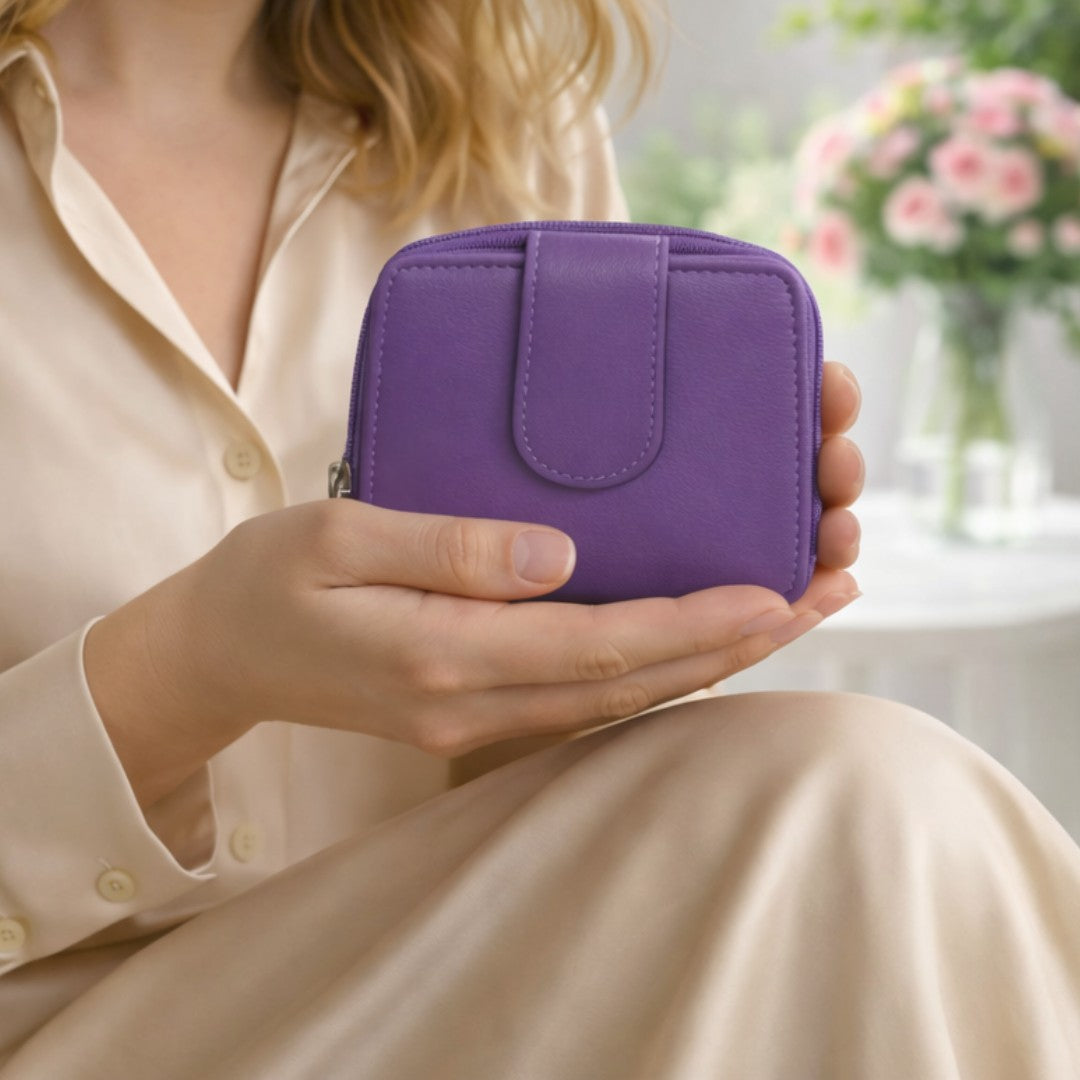 Woman holding a dark purple soft Nappa leather RFID purse indoors, showing compact size and elegant everyday use