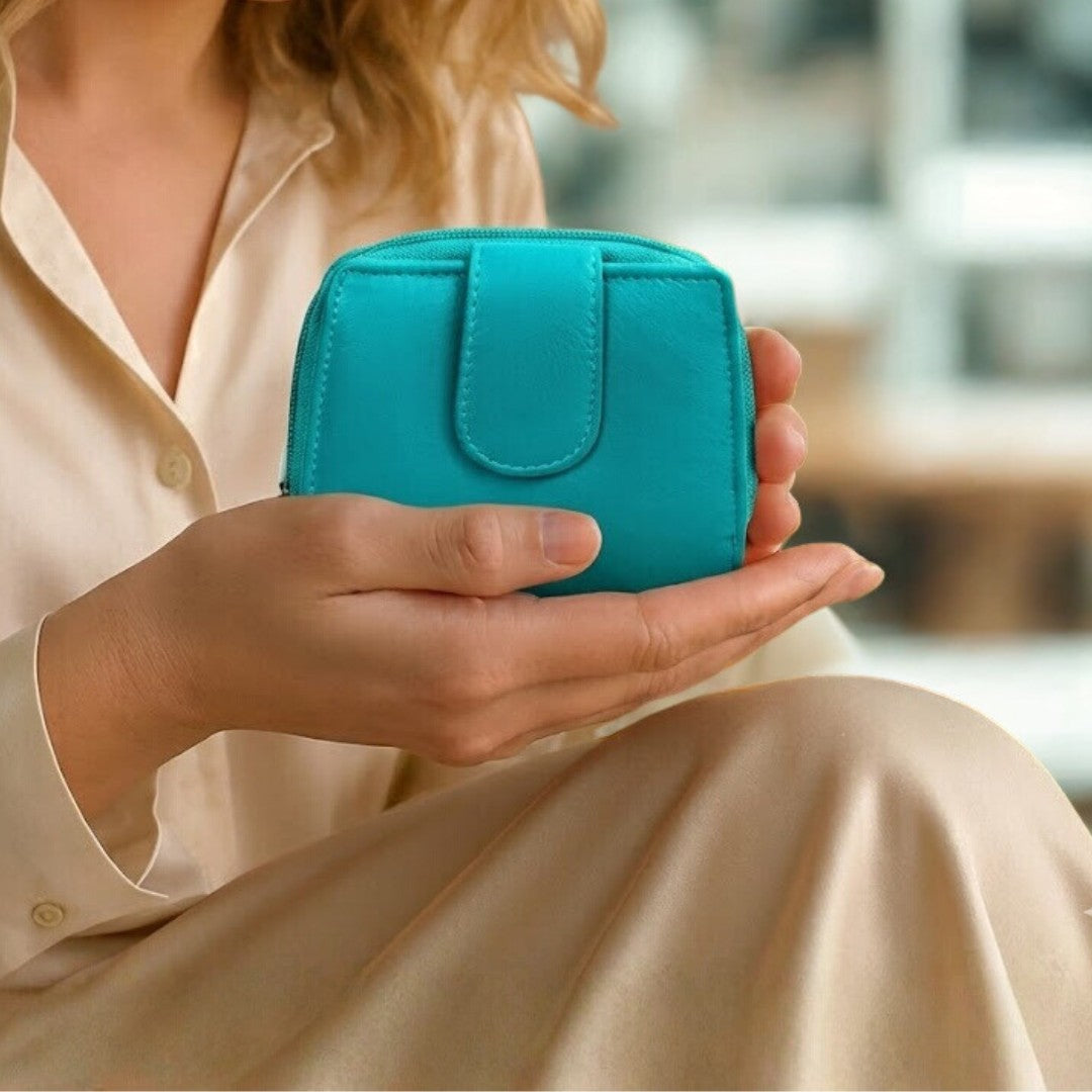 Woman holding a turquoise soft Nappa leather RFID purse indoors, showing compact size and elegant everyday us