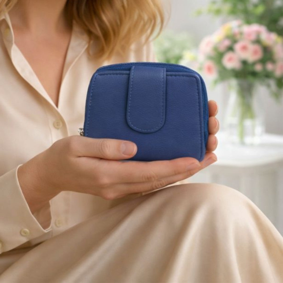 Woman holding a navy blue soft Nappa leather RFID purse indoors, showing compact size and elegant everyday use