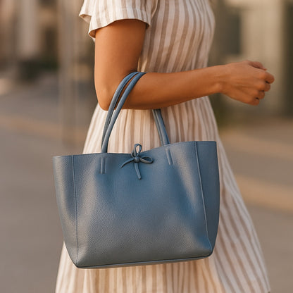 Denim blue real leather tote bag lifestyle view of bag on arm real leather denim, showing craftsmanship and detail.