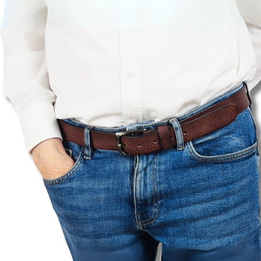 Brown leather belt threaded through denim jeans, highlighting buckle and smooth finish