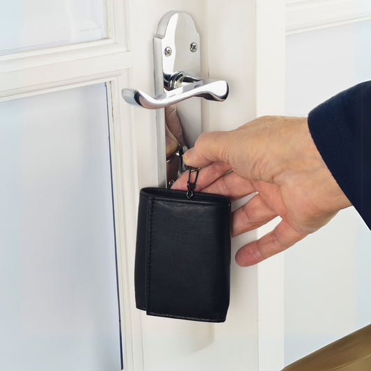 Compact black leather wallet closed, showing its smooth and minimalist design