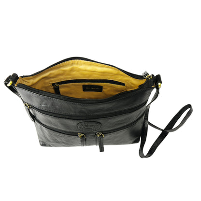 Interior view of a black leather crossbody bag with lining