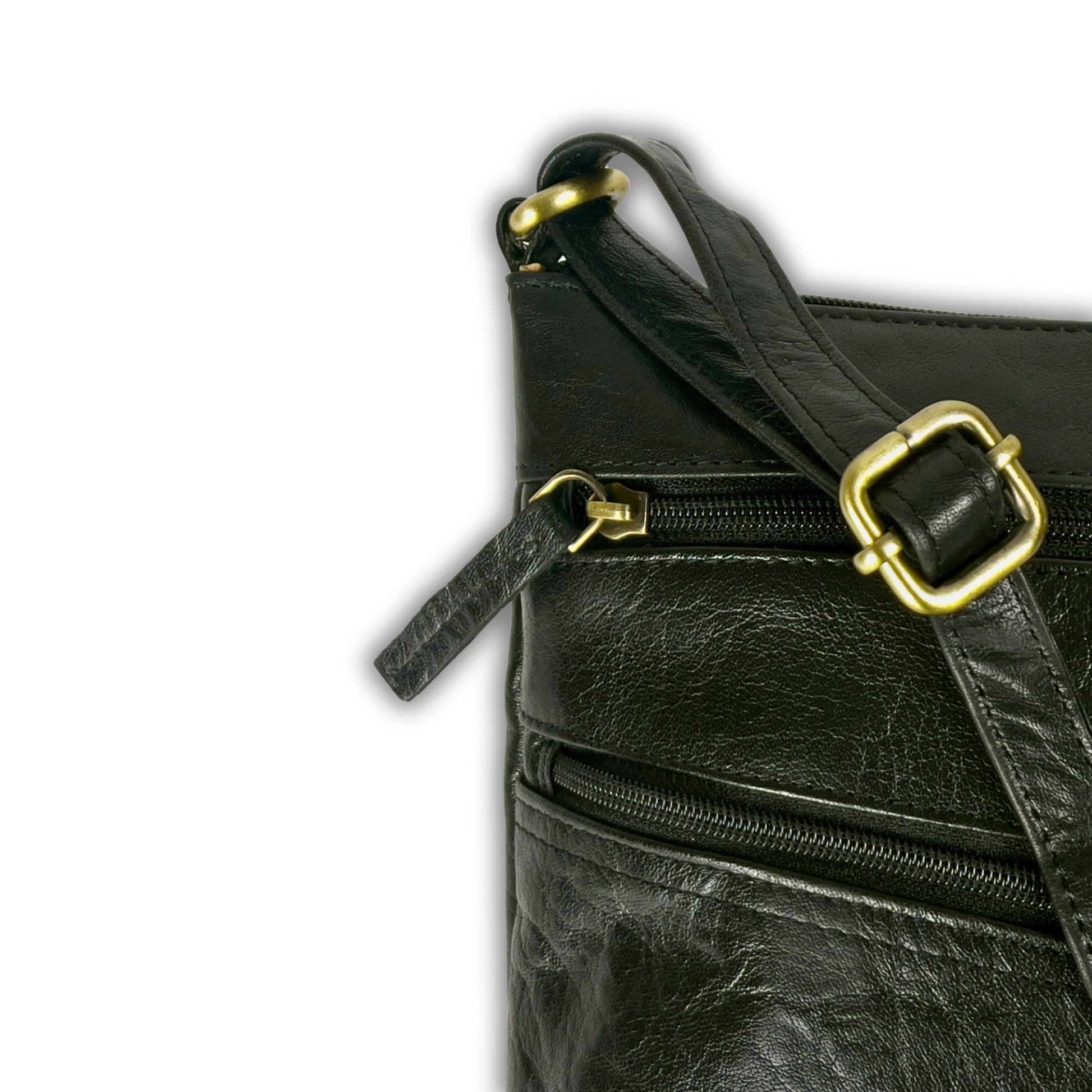 Close-up of the strap detail on a black leather crossbody bag