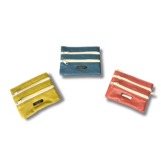 Three real leather coin purses in beige, blue, and red, arranged to showcase multi-zip functionality