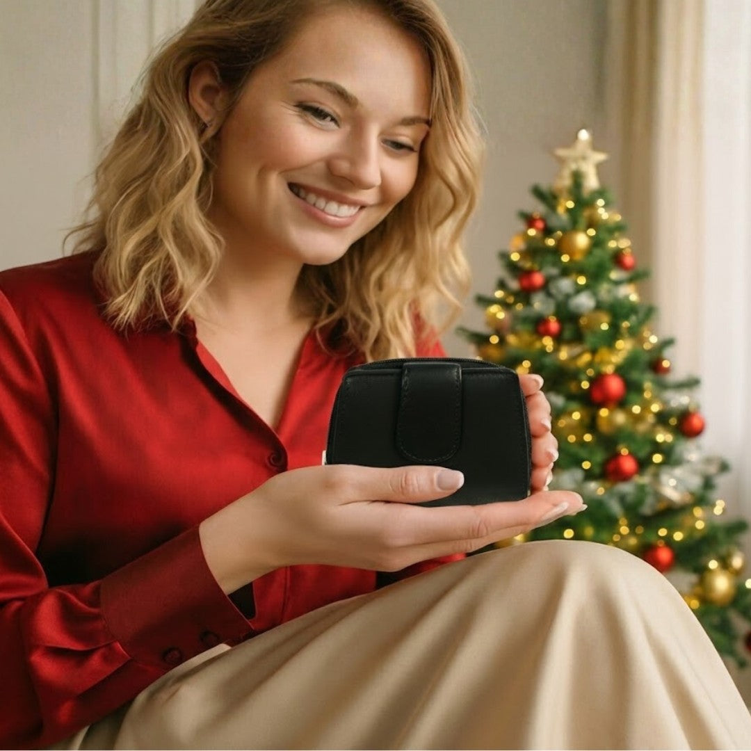 Woman gifting a soft Nappa leather RFID wallet during a festive celebration, showing ribboned gift box and joyful expression